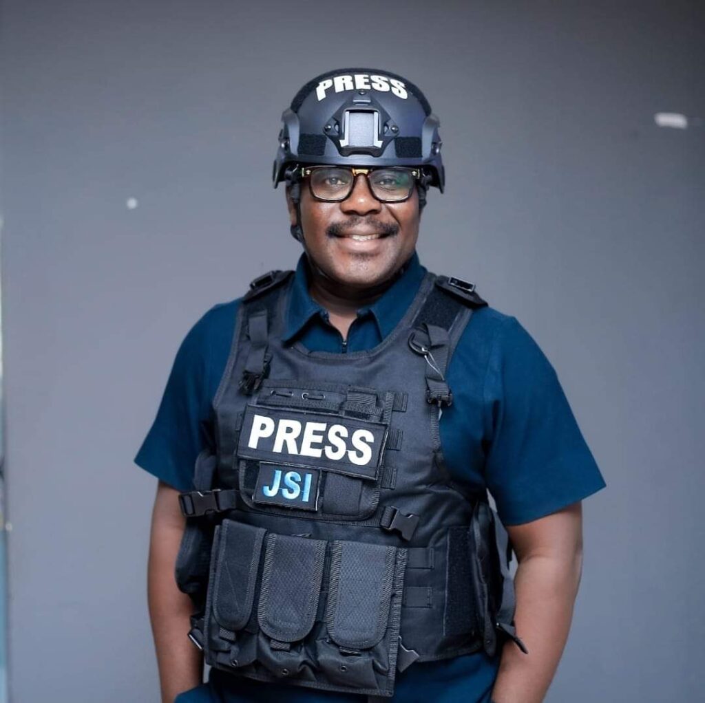 Johnnie Beresford Hughes of TV3 happily posing for the cameras in protective gears donated to TV3 by Journalists Sanctuary International